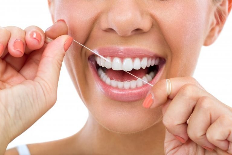 sutton woman with best oral hygiene routine flossing teeth