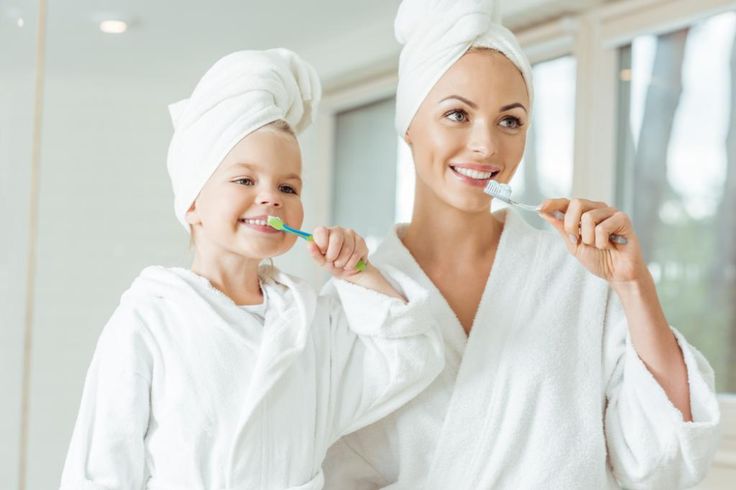 sutton mother and daughter with best oral hygiene routine brushing teeth