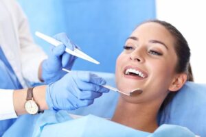 dental emergency in sutton belmont woman patient smiling in dental chair with dentist