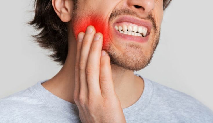 dental emergency in sutton belmont man holding face in pain