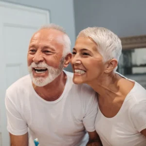 dental implants in belmont sutton man and woman couple smiling white smile 