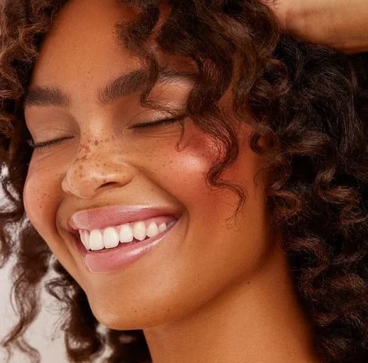 woman smiling with white teeth dental implants in belmont sutton