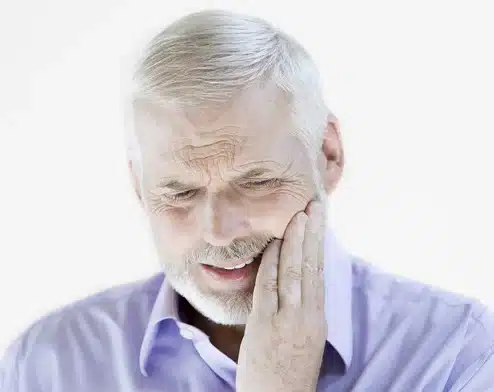 Man in pain from mouth ulcer at Pine Dental