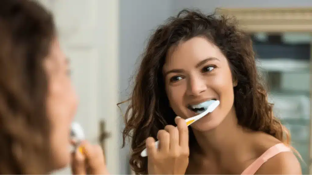Lady brushing her teeth